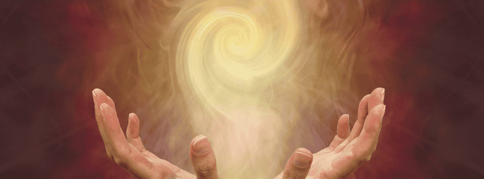 Ihmisen kädet ylläpitämä energiapallo, symboloi parantavaa voimaa ja hyvinvointia.