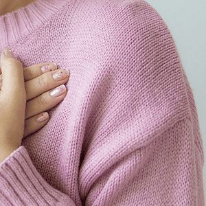 Nainen, joka pitää käsiä sydämen päällä, symboloi sisäistä rauhaa ja itsetuntemusta.